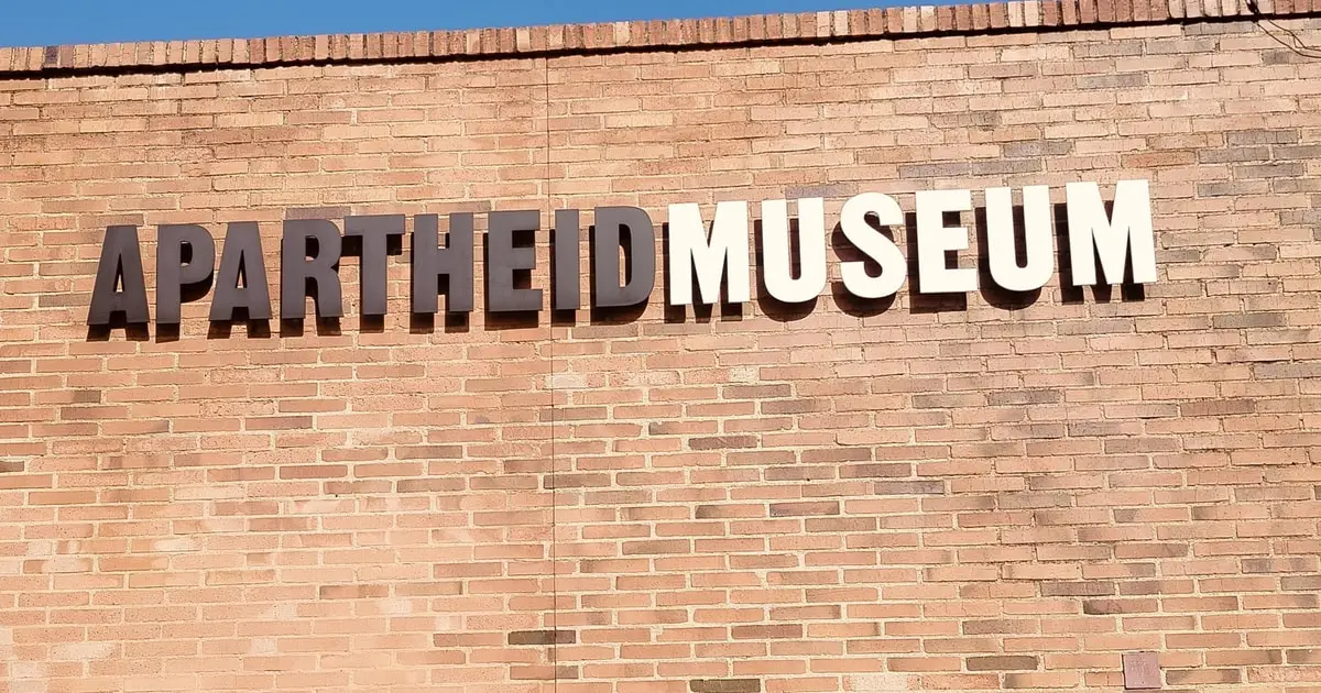 Guide walking visitors through the Apartheid Museum entrance ramp