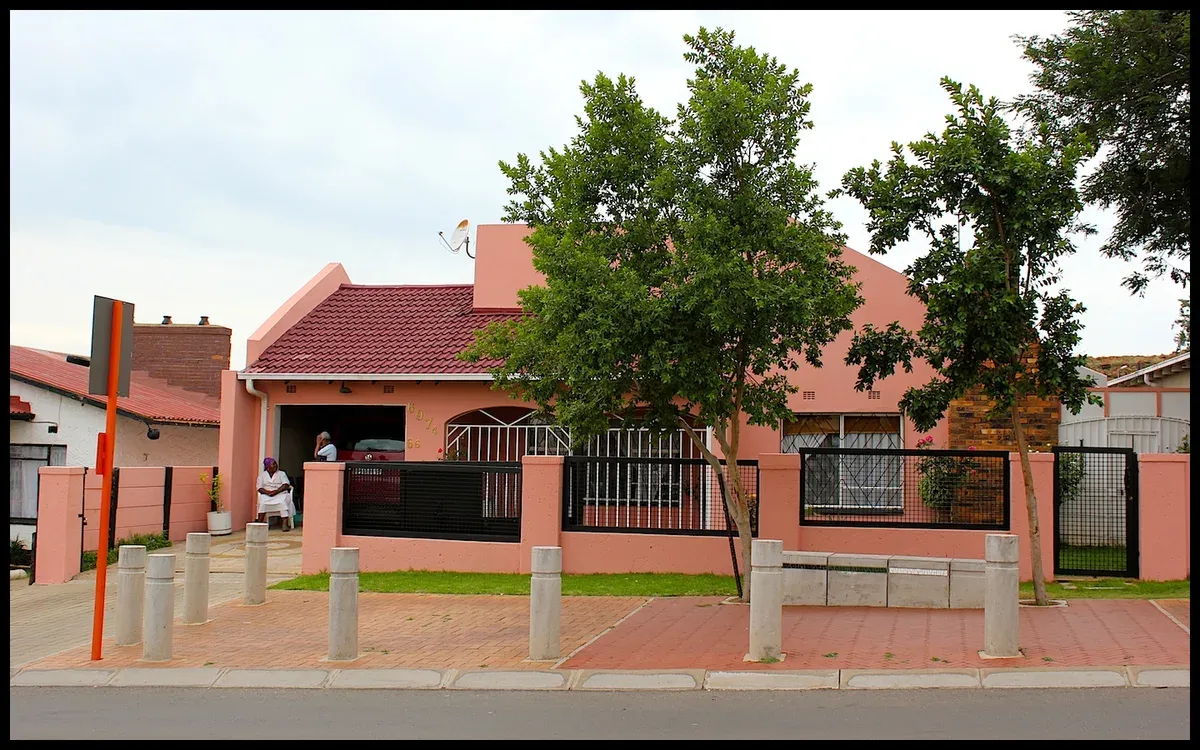 Houses and trees along Vilakazi Street in Soweto on a bright day
