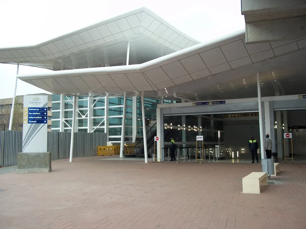 The street entrance to Gautrain Sandton station, marked by the network's blue and yellow signage