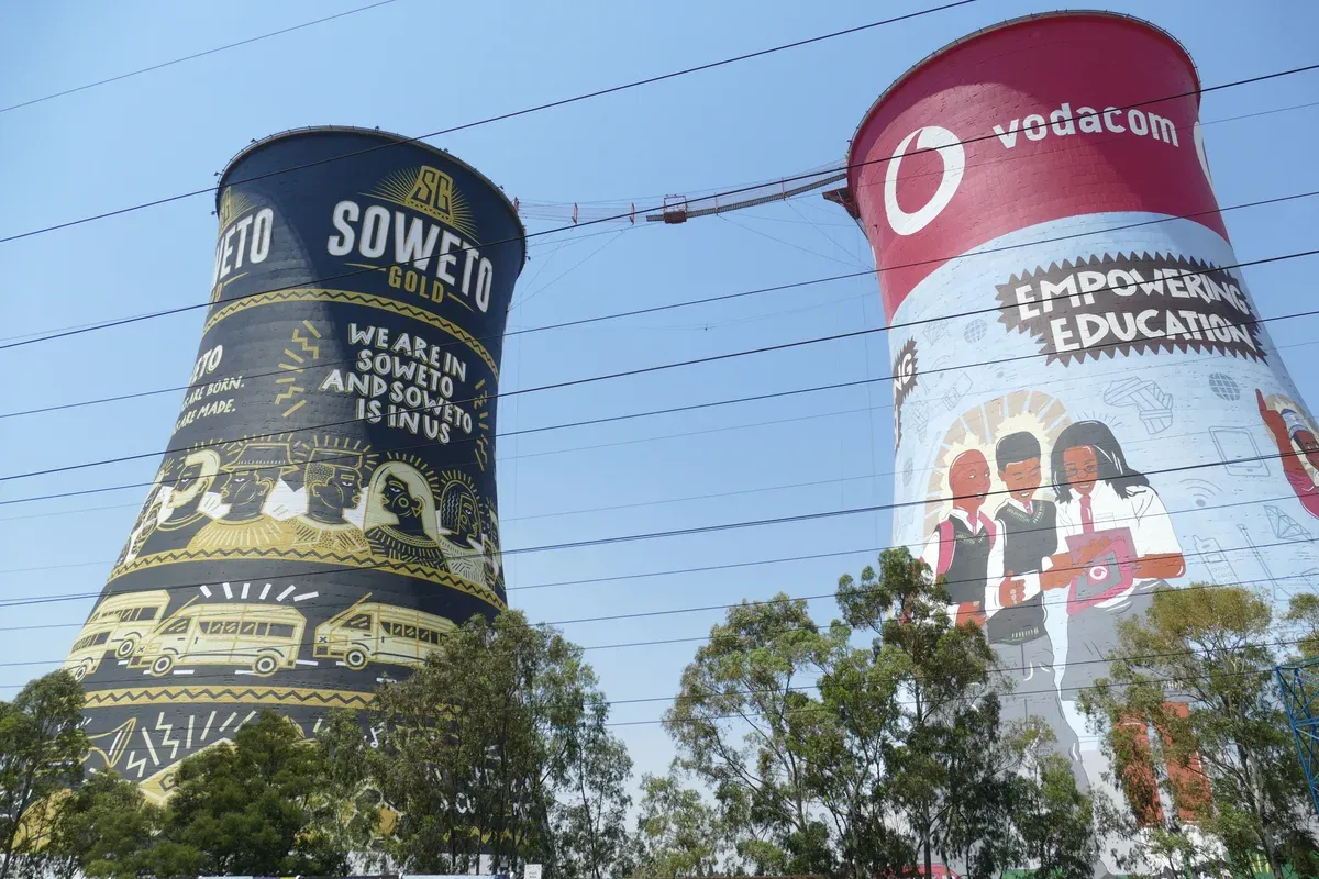 The painted Orlando Towers seen from ground level, murals running up the concrete shafts